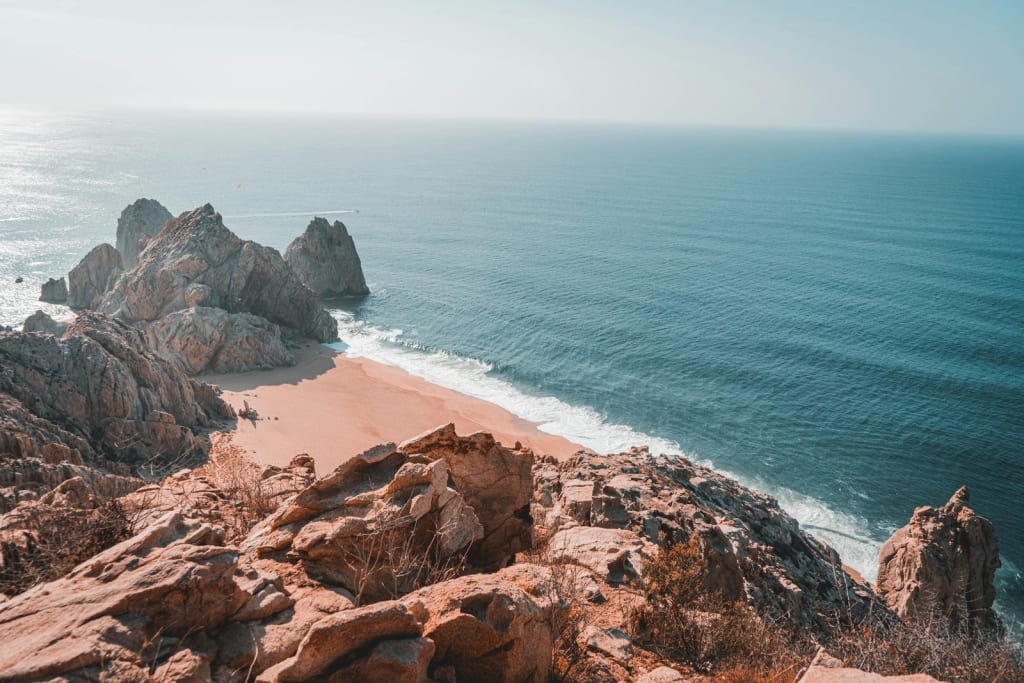 Breathtaking ocean view from rocky cliffs hidden gem in Cabo San Lucas, Mexico.