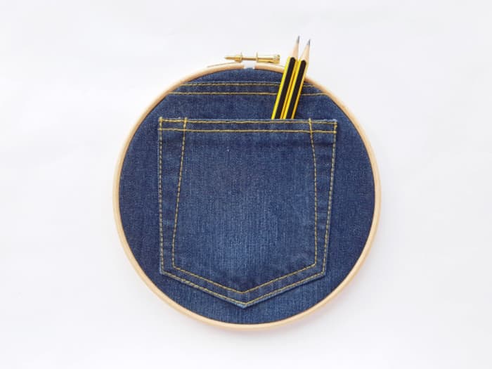 Denim pocket framed into an embroidery hoop.