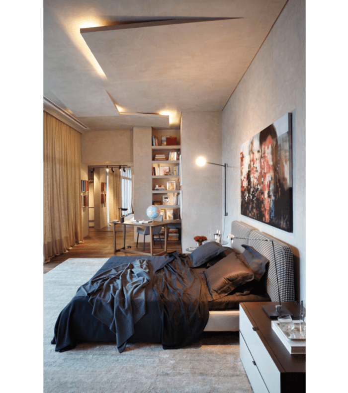 The concrete ceiling in this bedroom seems sliced and thus conceals the lighting body.