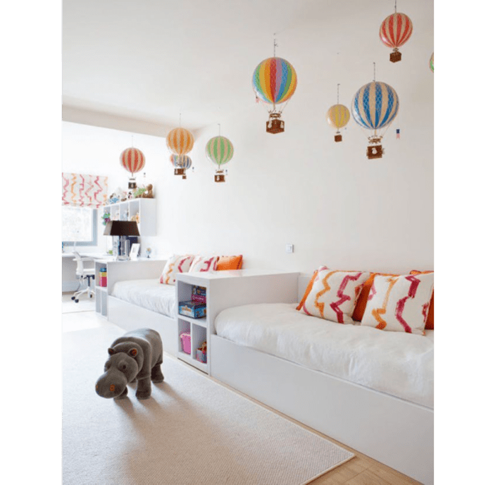 Colourful hot-air balloons drop down from a pure white ceiling. Colourful hot-air balloons dropping down from a pure white ceiling.