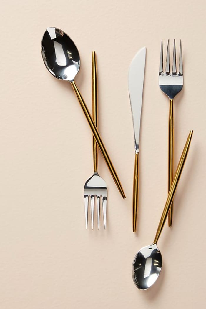 Minimalist cutlery set with shiny gold and silver colours; Gold by Anthropologie. Minimalist cutlery set with shiny gold and silver colours; Gold by Anthropologie.