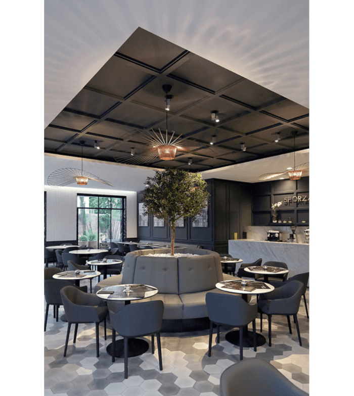 Restaurant interior with modern-looking black coffered ceiling.