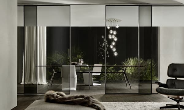 Glass partition bewteen living and dining room, great example of biophilic design.