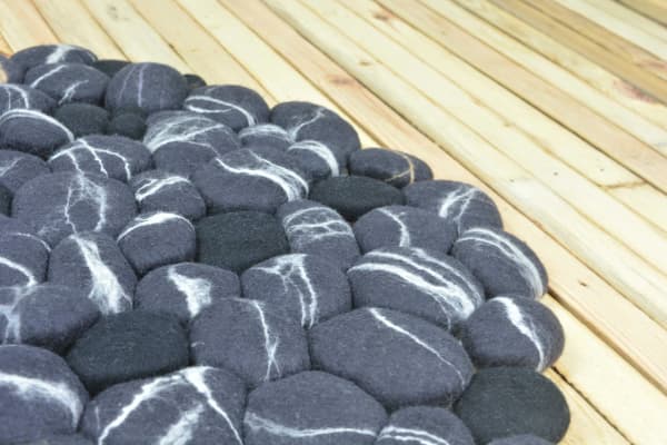 Close-up of a felt stone rug.