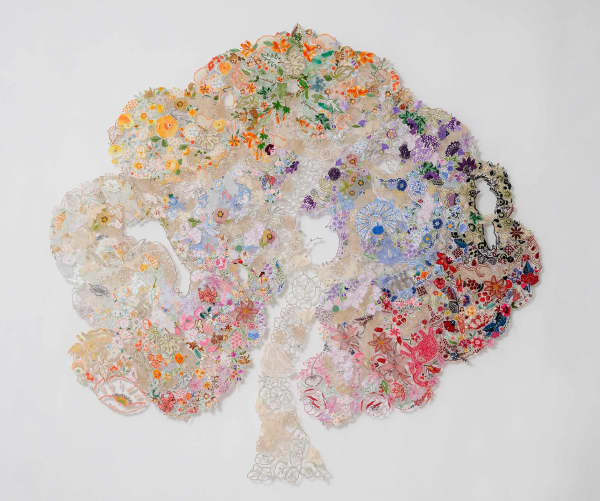 Textile art tree made up of reused pieces of needlework, pins and tulle.