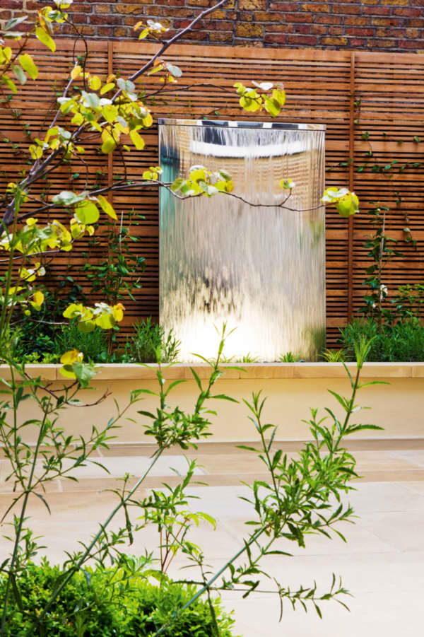 Outdoor water wall, great element to a biophilic outdoor design.