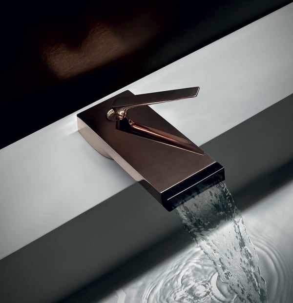 A waterfall faucet on a modern bathtub, adding a biophilic twist to a natural bathroom design.