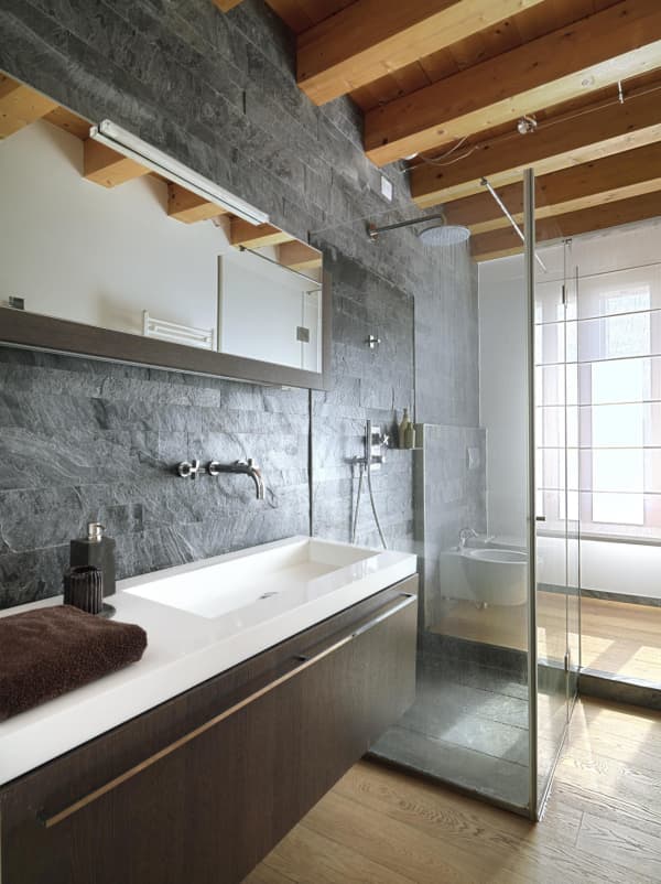 Bathroom with stone and wood finishes.