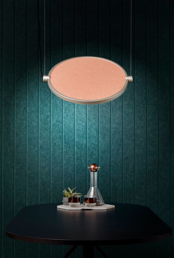 An acoustic panel used as a decorative wall finish. With its teal colour and striped texture it substitutes a wallpaper perfectly.