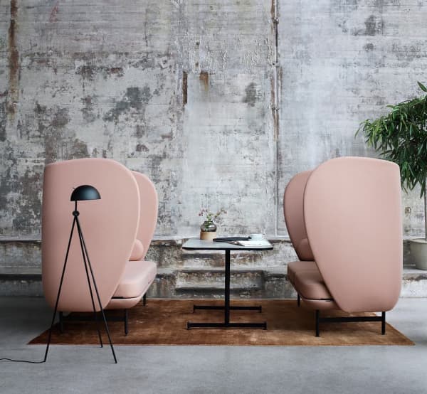 Acoustic pink chairs with a high and enveloping back.