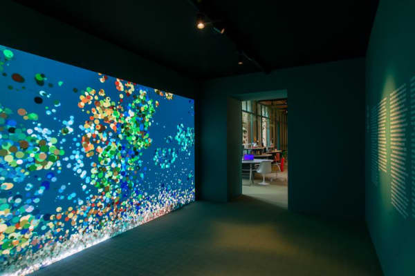 An interactive wall translating passing people into moving dots.