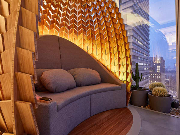 Close-up of the indoor of a wooden retreat pod with a shape that recalls a pinecone.