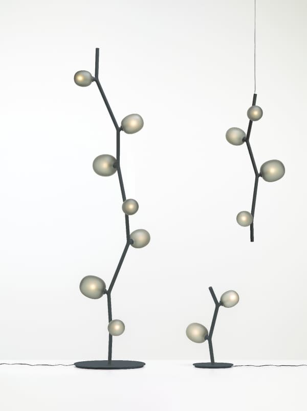 Floor lamp recalling the shape of a branch (the structure) with leaves (the bulbs).