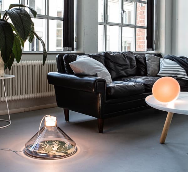 Bacteria lamp sitting on the floor in a living room.
