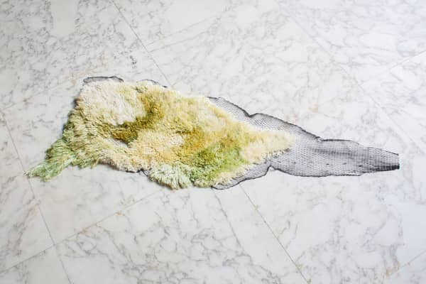 Sustainable design rug made of seaweed yarn and fishing net.