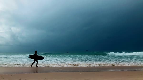 A surfer on the beach.