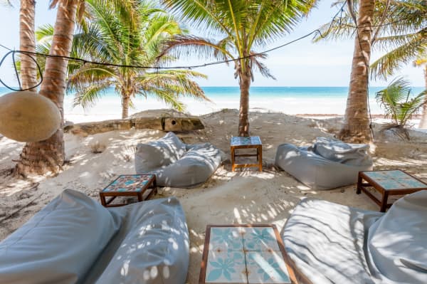 The outdoor lounging area of Casa Nalum sits directly on the beach.