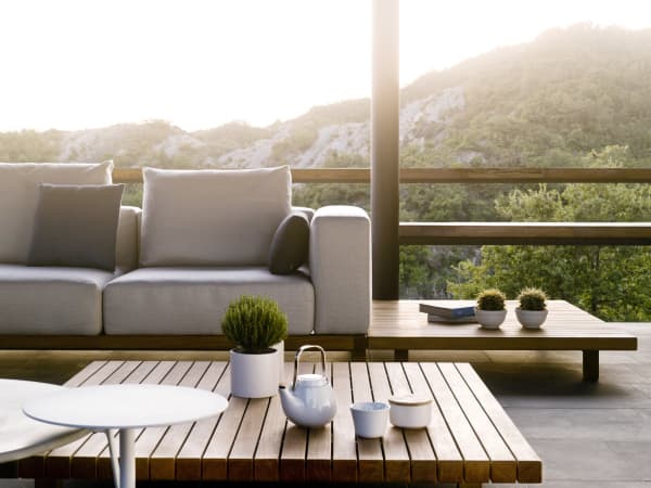 Outdoor sofa and matching coffee table in teak wood.