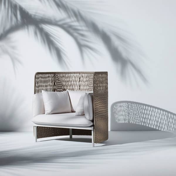 High back white outdoor sofa with a woven back.