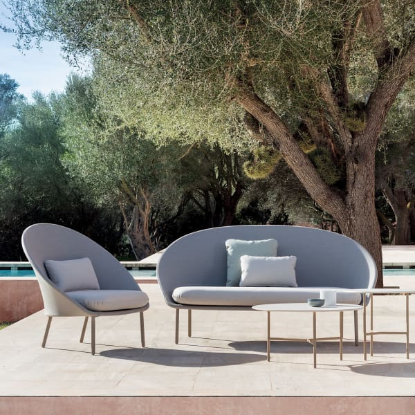 Outdoor sofa and chair with a curved profile.
