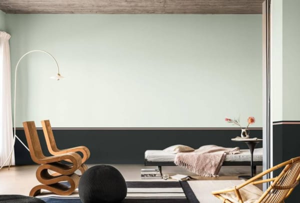 Biophilic living room with Tranquil Dawn and charcoal striped walls and minimal furniture.