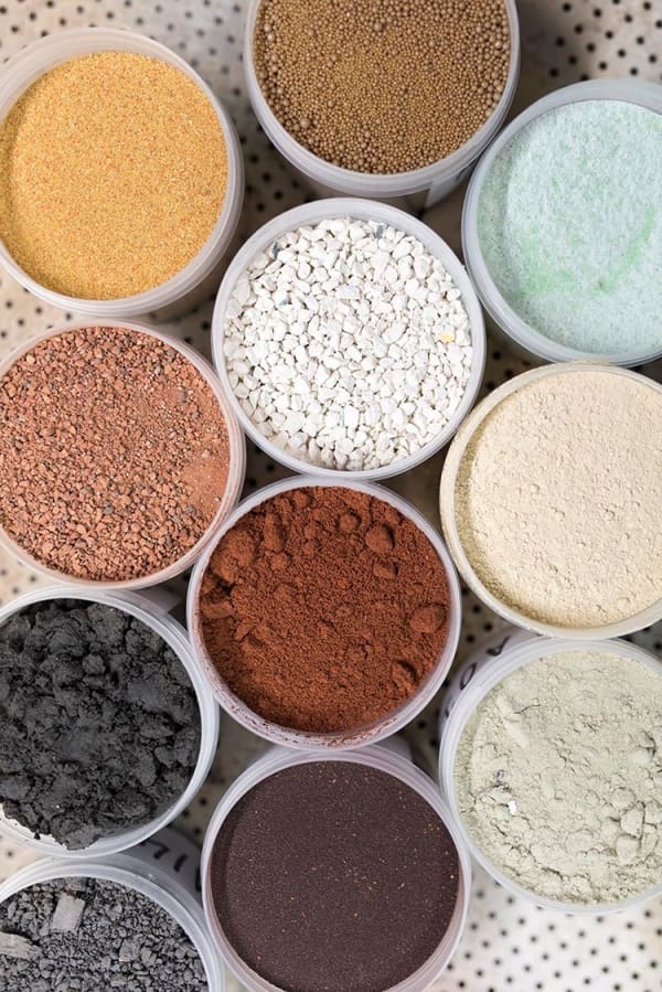 Crushed demolition debris sorted by colour, that are the the raw material of waste-based bricks.