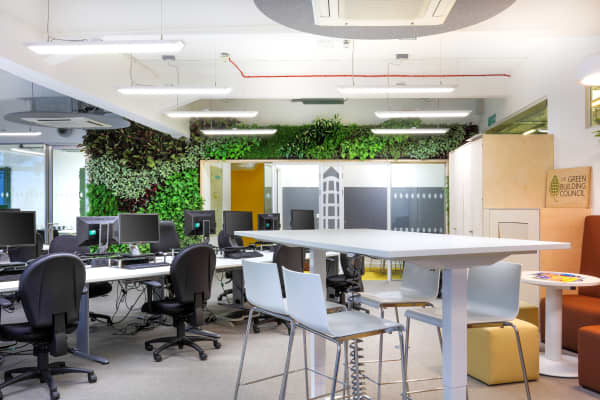 Office furnished with refurbished and reused pieces.