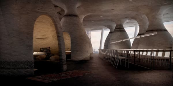 Restaurant with some tables enclosed into artificial rock caves.