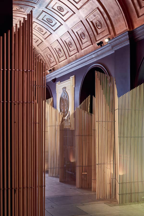 Tall room dividers made assembling wooden dowels beside each other.