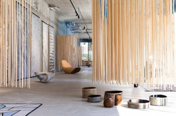 View of last year's scenography, with wooden dowels hanging from the ceiling.