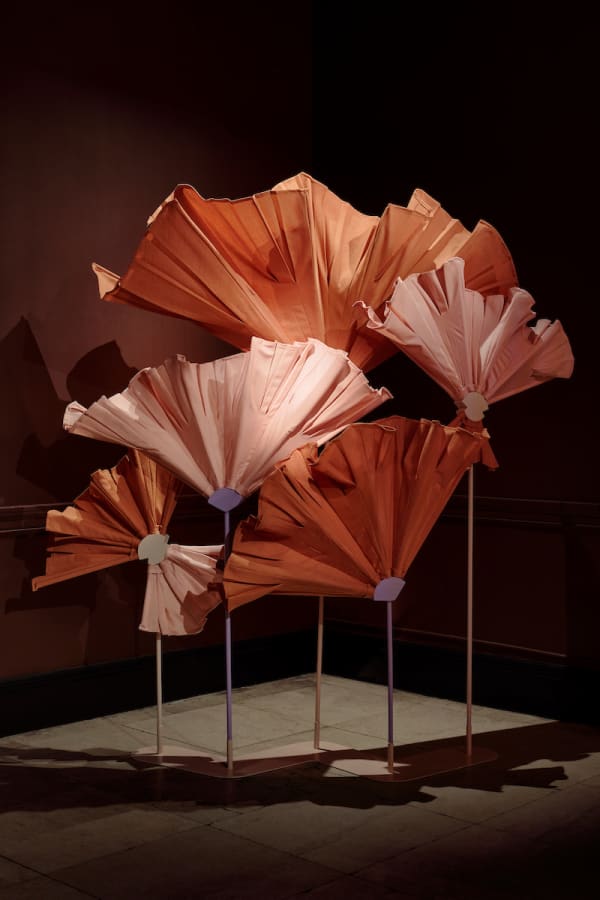 Flower-shaped screen with a wooden dowel as stem and leftover fabric as petals.