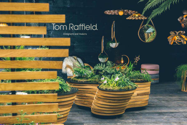 Booth enclosed in a wood structure with natural materials and greenery.