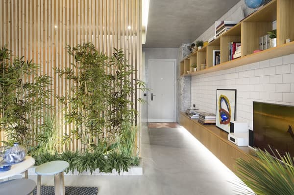 Partition wall made of wood pillars and plants to add coverage.