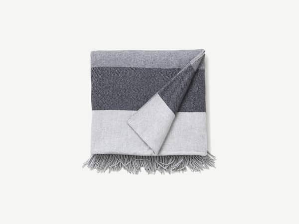 Striped blanket in different shades of grey.