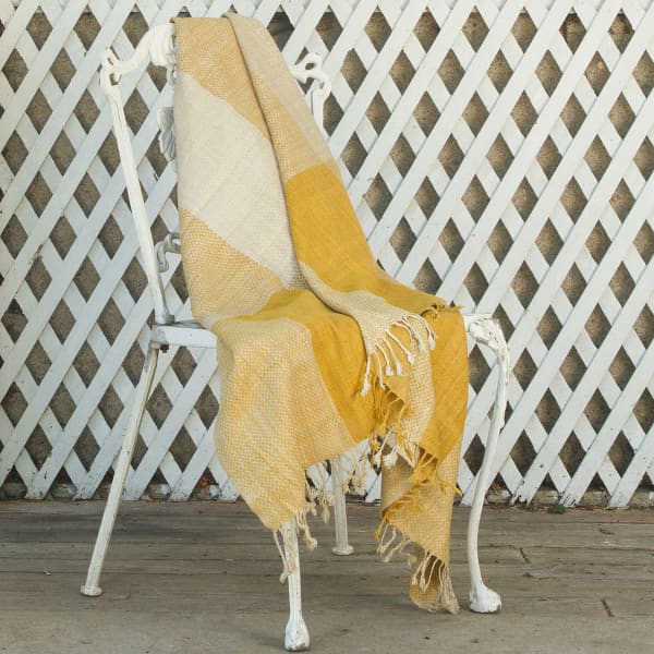 Blanket laying on a white metal chair.