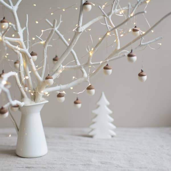 Branch decorated with acorns with a felt body mounted on real tops.