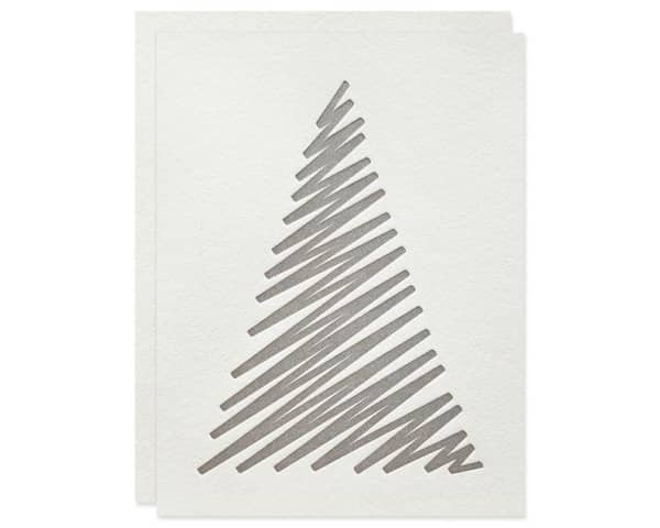 White Christmas card decorated with a simple drawn tree.
