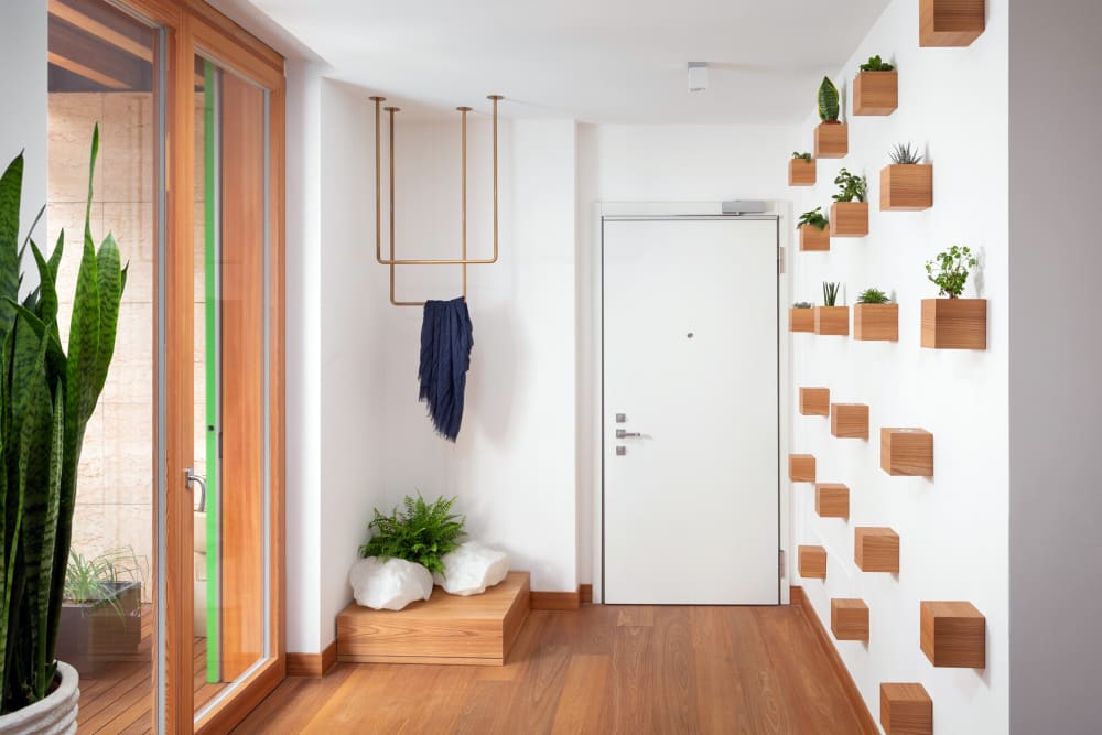 Contemporary entryway with small plants creating a pattern on the wall.<span class="sr-only"> (opened in a new window/tab)</span>
