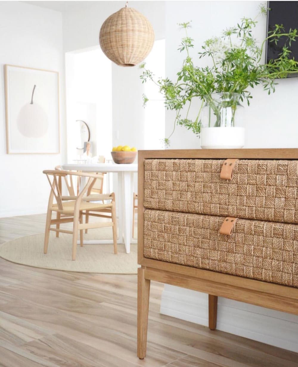 Biophilic entryway with greenery and woven dresser.<span class="sr-only"> (opened in a new window/tab)</span>