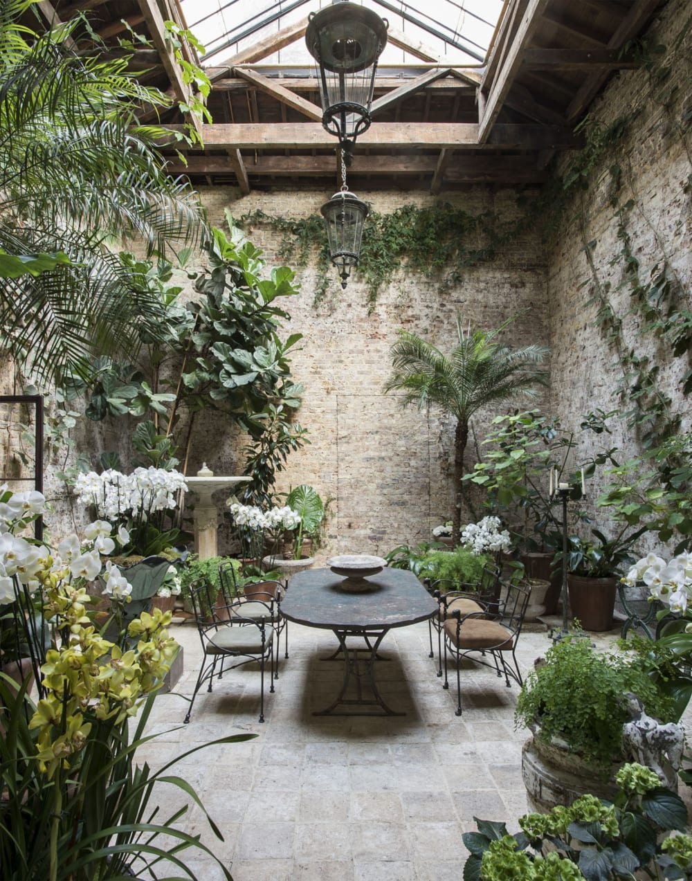Tall room full of plants with a dining table in the middle.<span class="sr-only"> (opened in a new window/tab)</span>