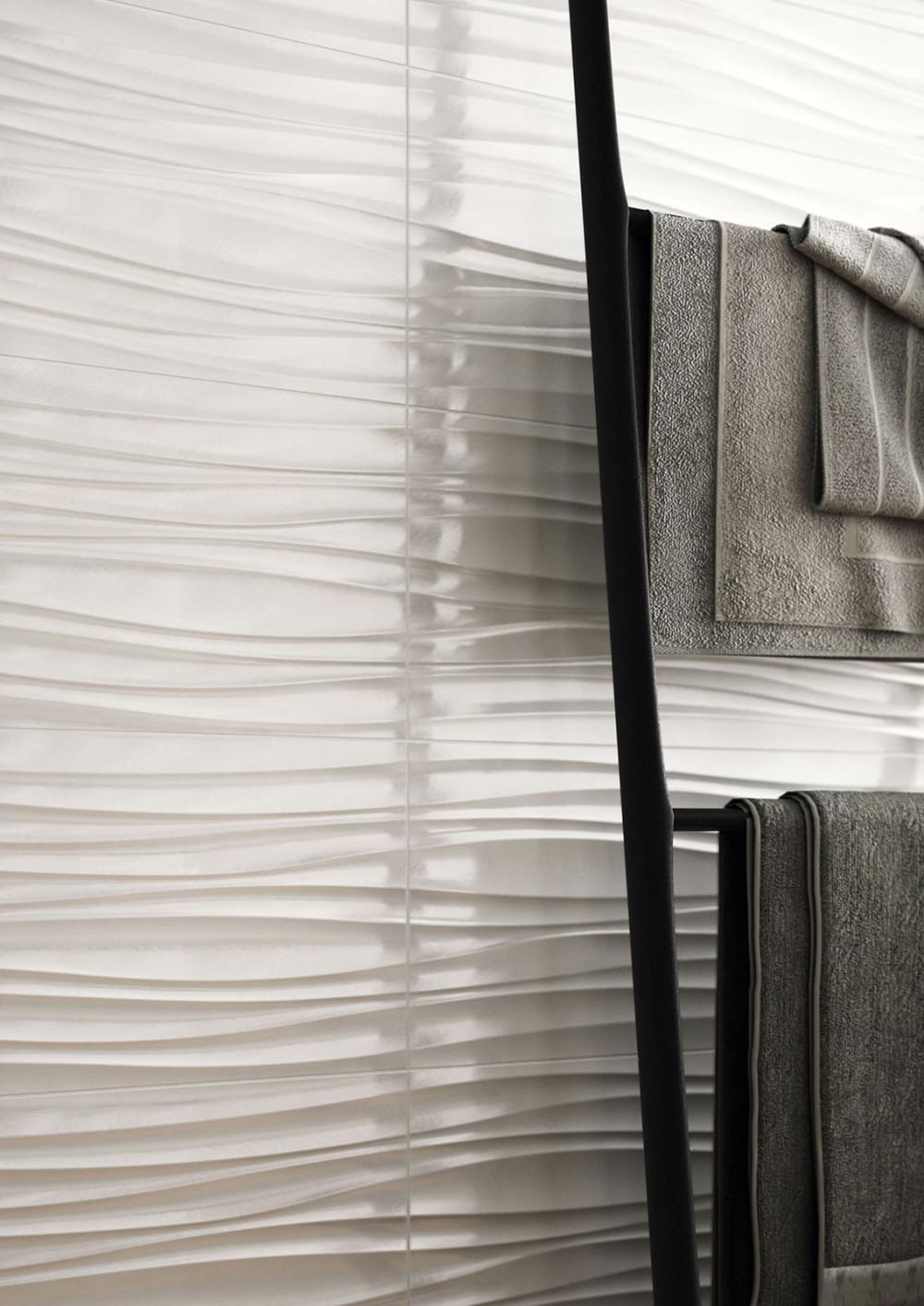 Close-up of textured wall tiles recalling the wavy shape of sand moved by the wind.<span class="sr-only"> (opened in a new window/tab)</span>