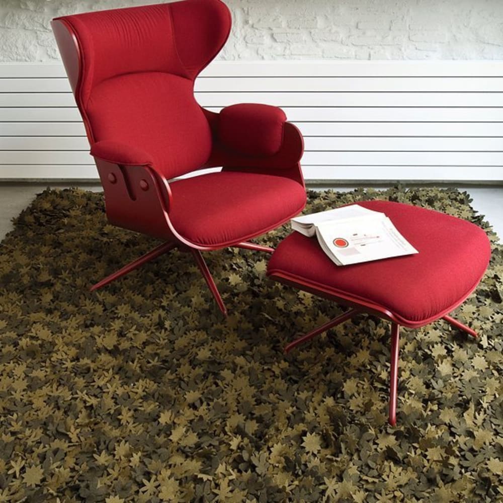 Red armchair on a rug made with little individual wood felt flowers.<span class="sr-only"> (opened in a new window/tab)</span>