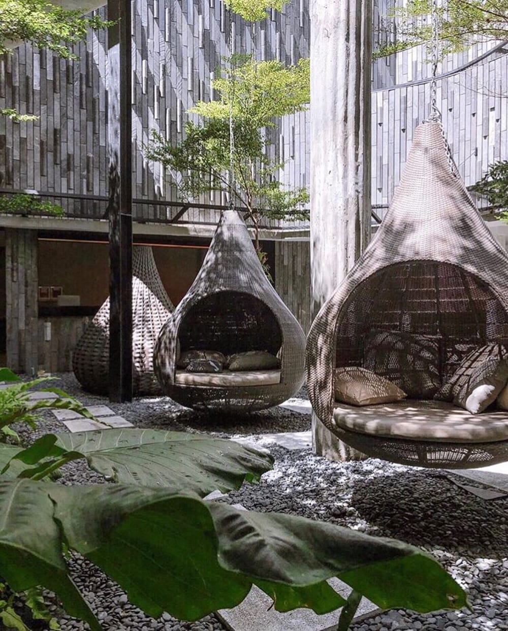 Outdoor refuge area with hanging chairs.<span class="sr-only"> (opened in a new window/tab)</span>