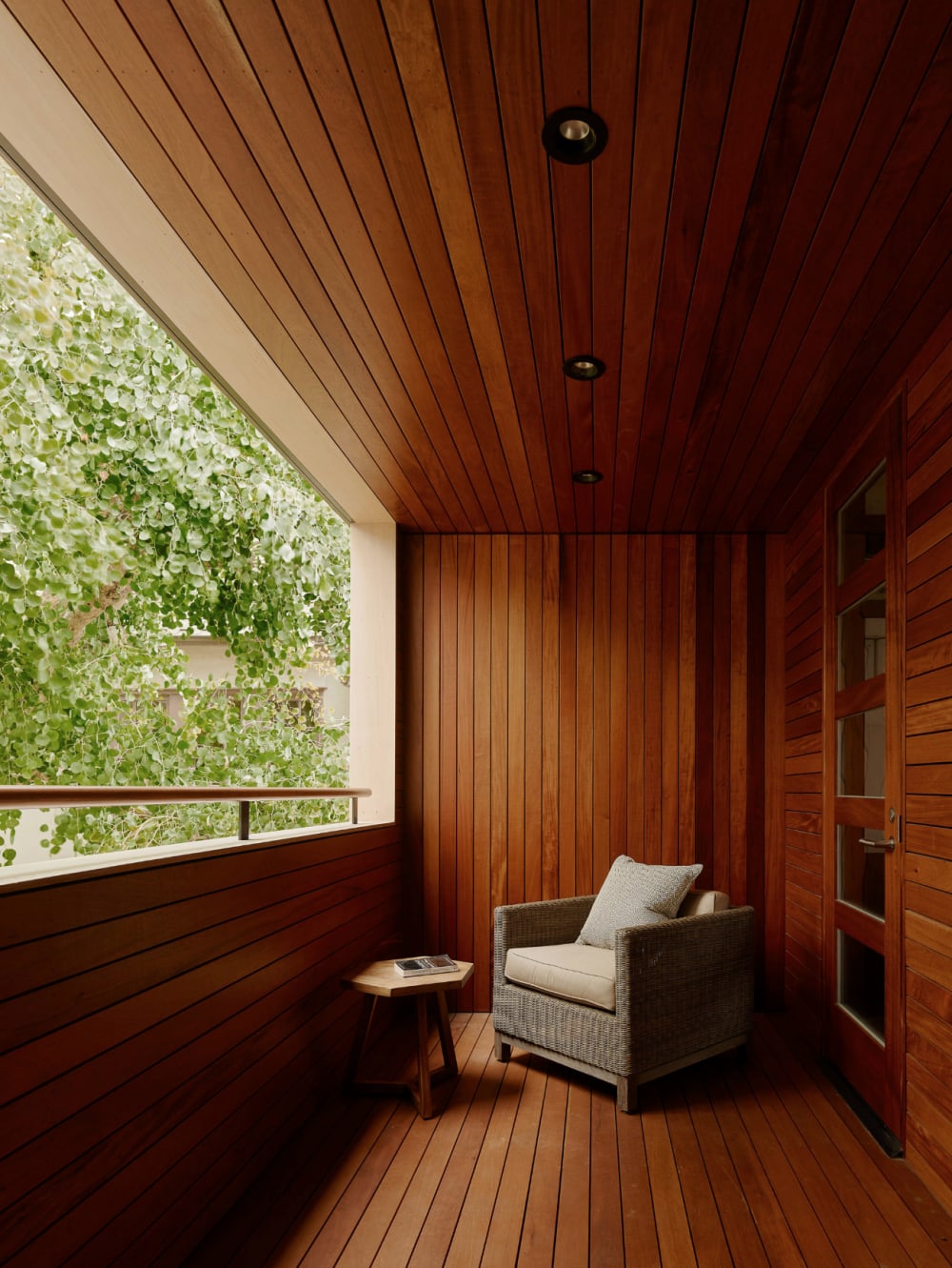 Armchair on a narrow balcony overlooking greenery.<span class="sr-only"> (opened in a new window/tab)</span>