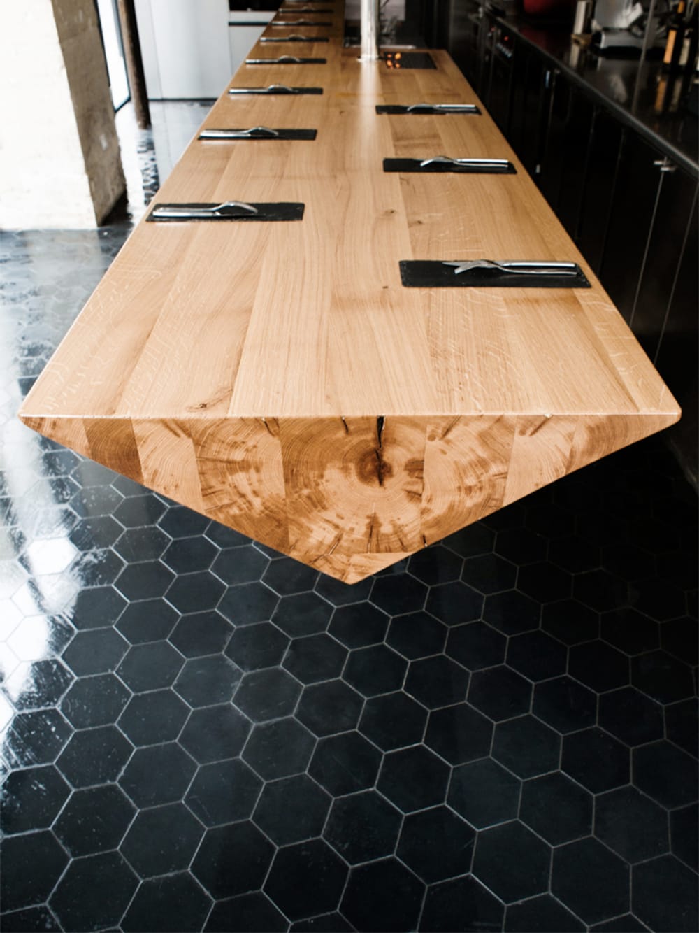 Table with swing-chairs hanging from the ceiling.<span class="sr-only"> (opened in a new window/tab)</span>