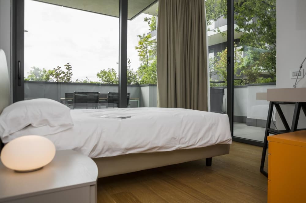 Bedroom in the Bosco verticale with view on the greenery.<span class="sr-only"> (opened in a new window/tab)</span>