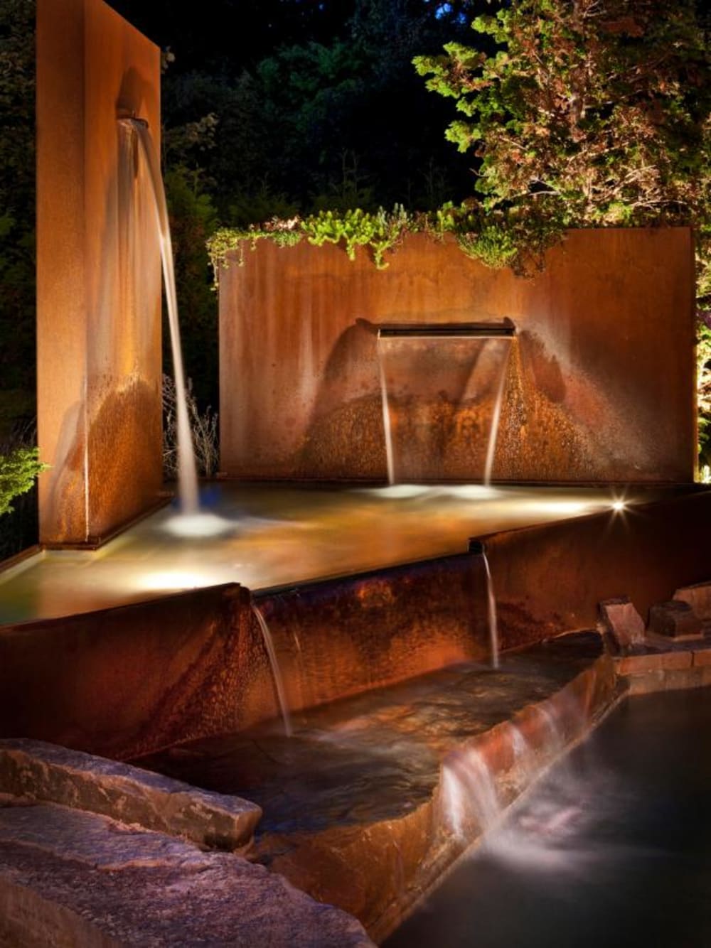 Waterfall coming out of steel panels. Great example of water design feature contributing to a more biophilic design of the space.<span class="sr-only"> (opened in a new window/tab)</span>
