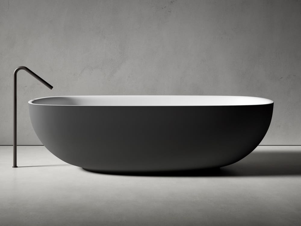 Bathtub with an oval shape and rounded floor-mounted faucet.<span class="sr-only"> (opened in a new window/tab)</span>