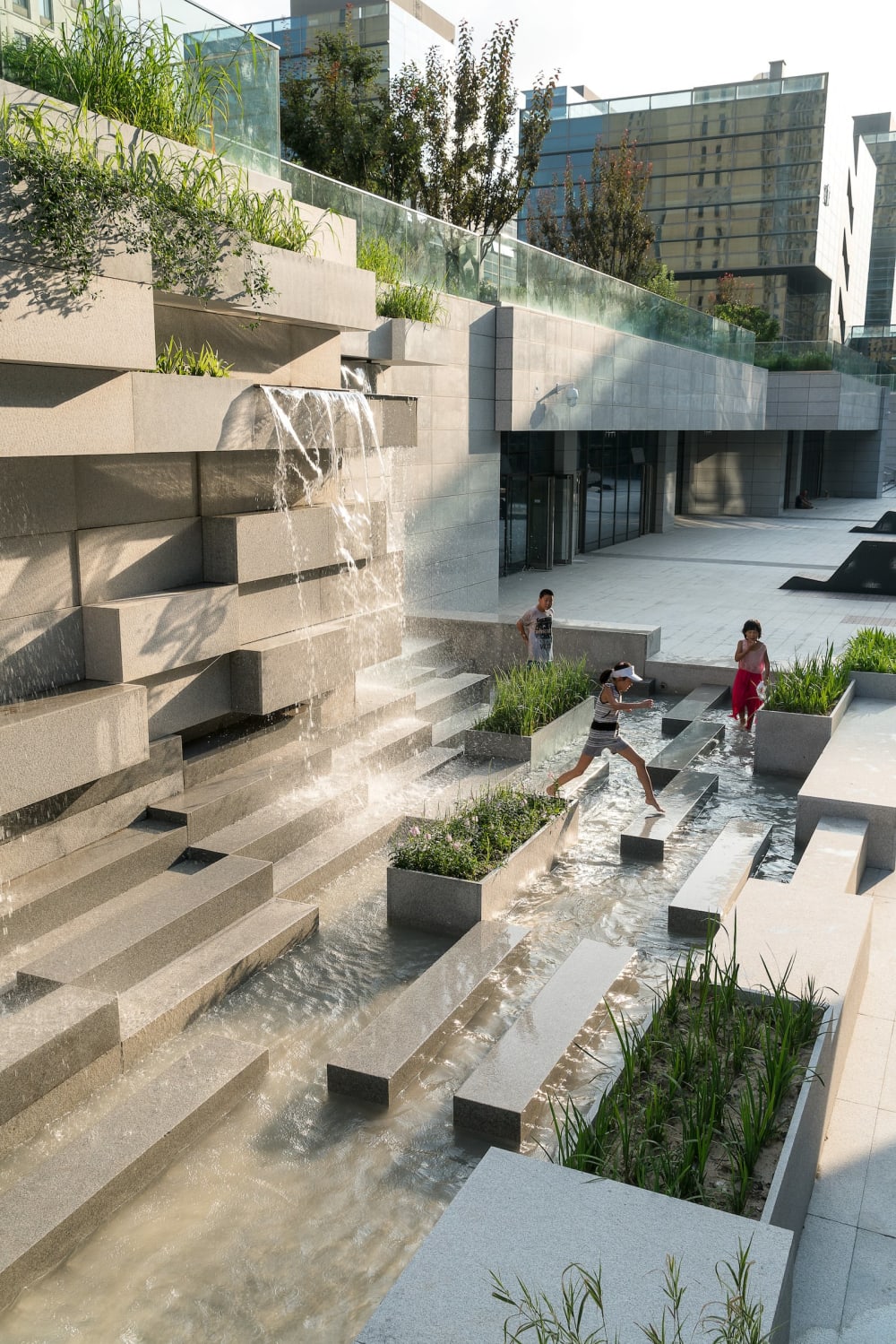 Water feature in a city invites children to play.<span class="sr-only"> (opened in a new window/tab)</span>