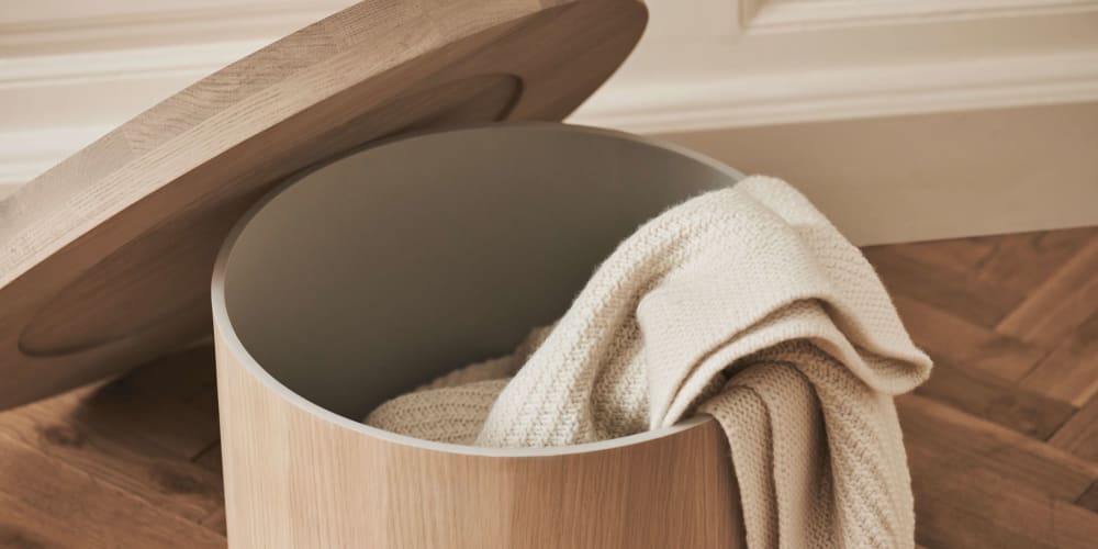 Wooden side table with hidden storage containing a blanket.<span class="sr-only"> (opened in a new window/tab)</span>